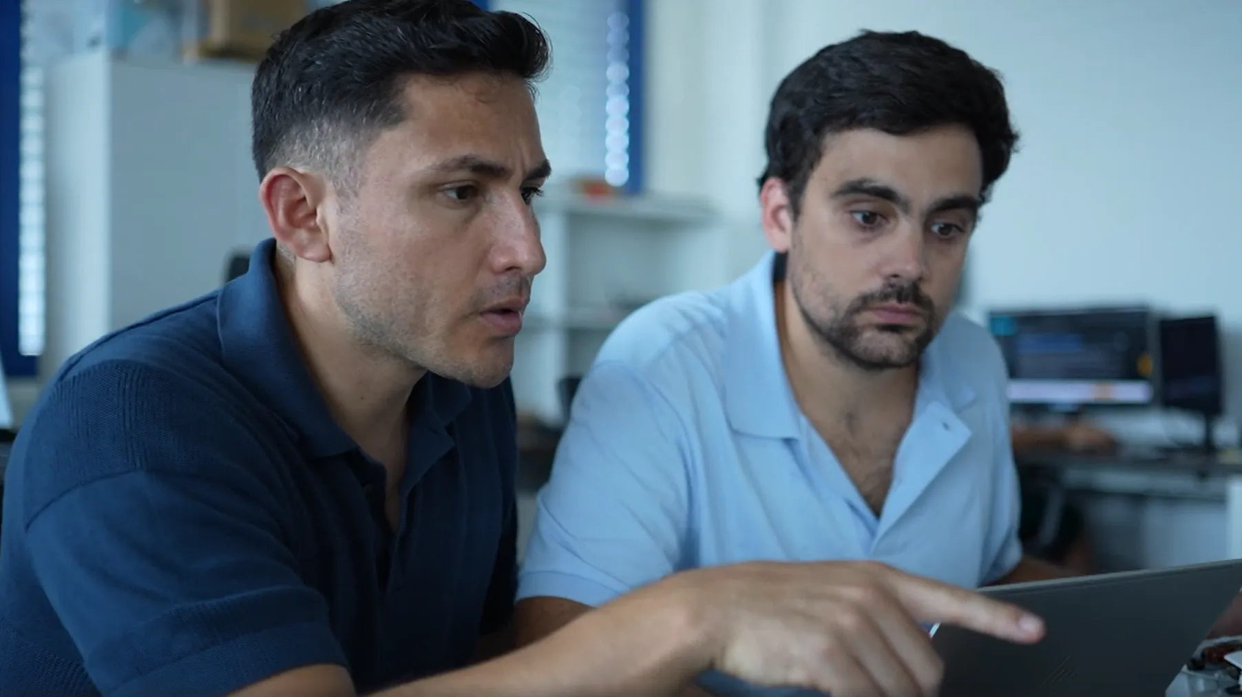 Two colleagues collaborating on a guided digital workflow